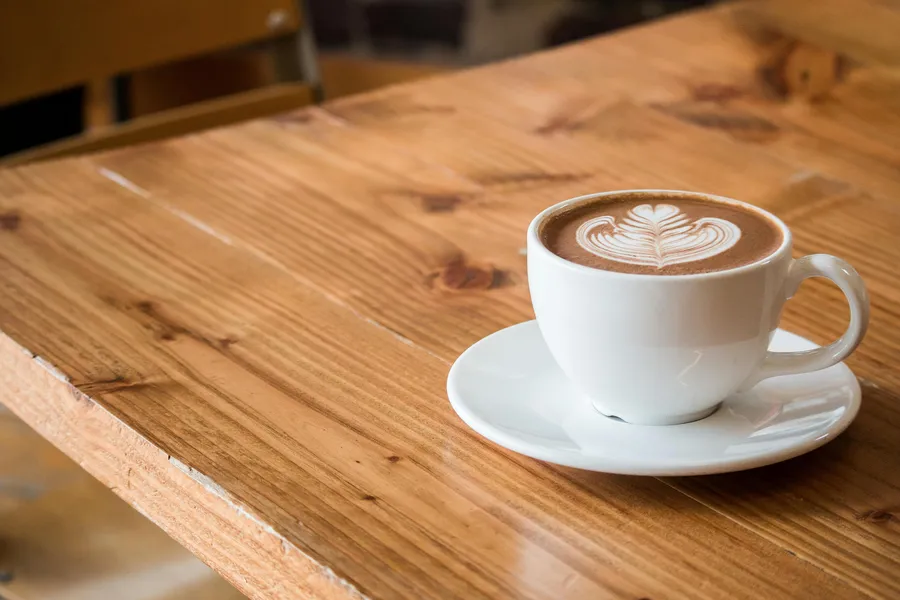A cup of coffee on a wooden table